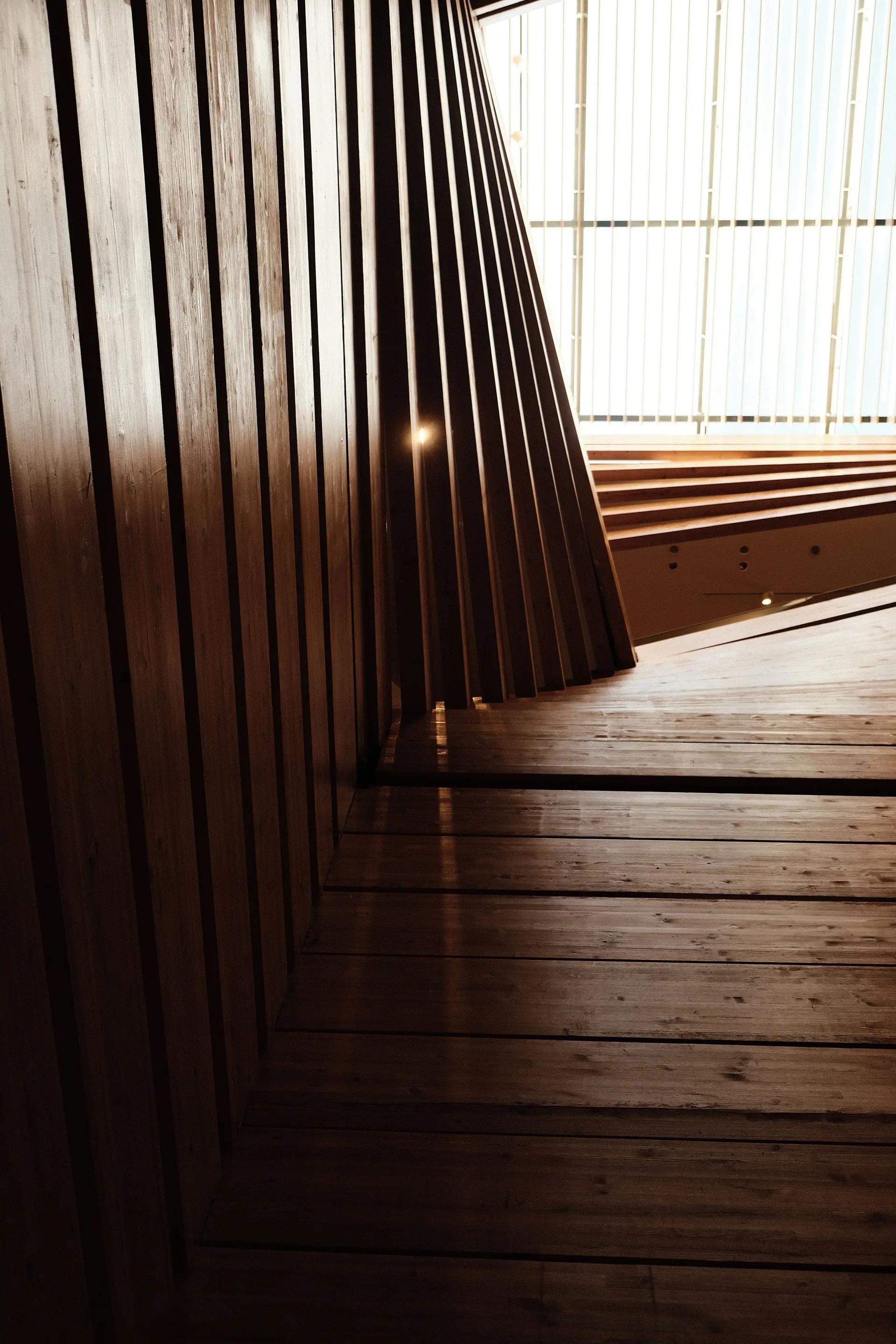 Sunlight streaming through architectural wooden structures